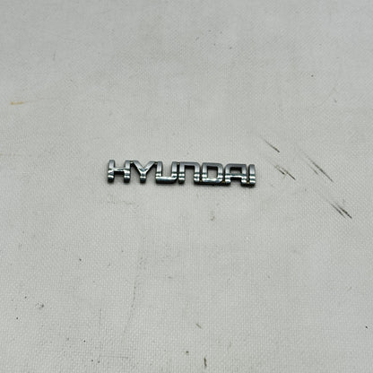 SCRITTA HYUNDAI LOGO EMBLEMA SIGA BADGE FREGIO ORIGINALE L-310